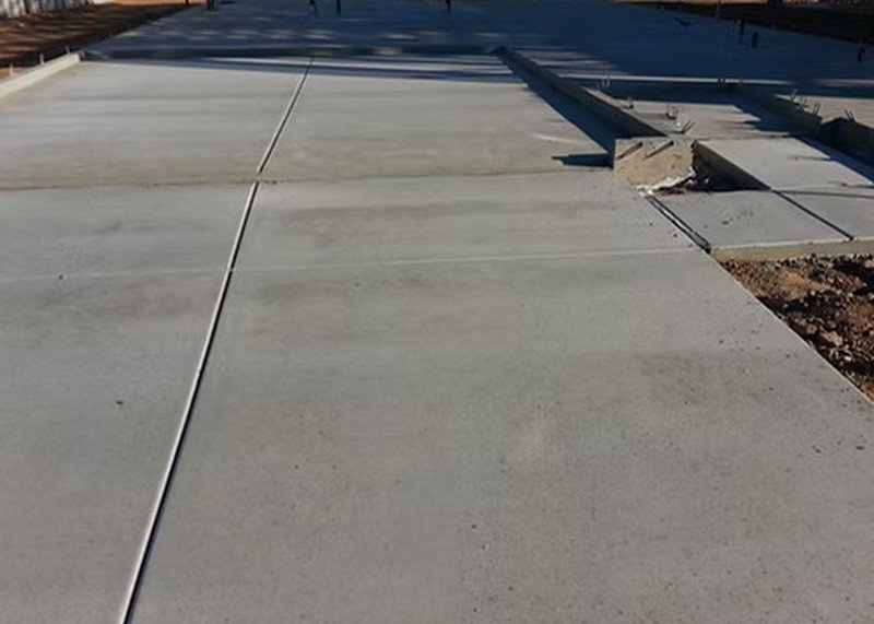 Colored concrete sidewalk with smooth finish and clean joints.